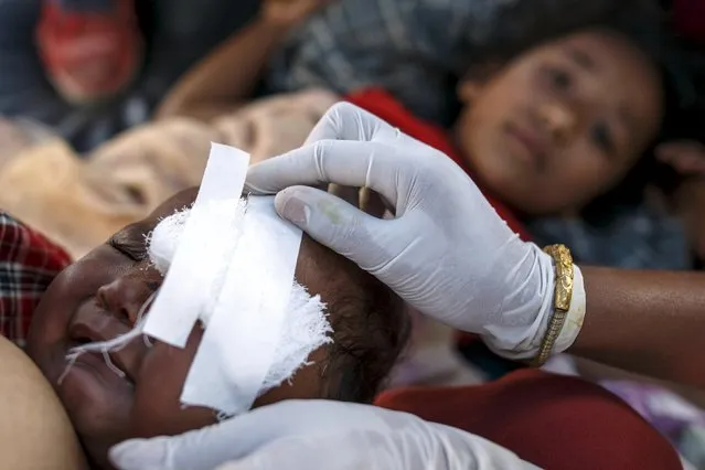 Injured eight-month-old Rakshya Shrestha receives medical treatment at Dhading hospital, in the aftermath of Saturday's earthquake, in Dhading Besi, Nepal April 27, 2015. (Photo by Athit Perawongmetha/Reuters)