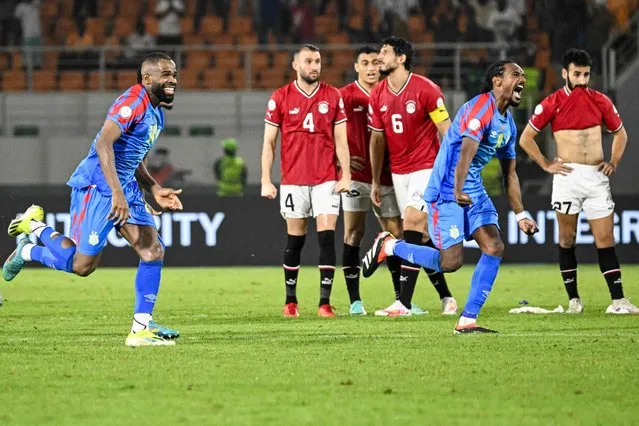 DR Congo's defender #24 Gedeon Kalulu (L) and DR Congo's midfielder #8 Samuel Moutoussamy (2R) celebrate next to  Egypt's players after winning at the end of the Africa Cup of Nations (CAN) 2024 round of 16 football match between Egypt and DR Congo at the Stade Laurent Pokou in San Pedro on January 28, 2024. (Photo by Sia Kambou/AFP Photo)