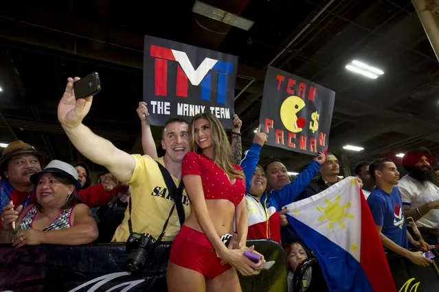 Mick Solak of Britain takes a selfie with Tecate Girl Vanessa Golub during a Manny Pacquiao fan rally at the Mandalay Bay Resort in Las Vegas, Nevada April 28, 2015. (Photo by Steve Marcus/Reuters/Las Vegas Sun)