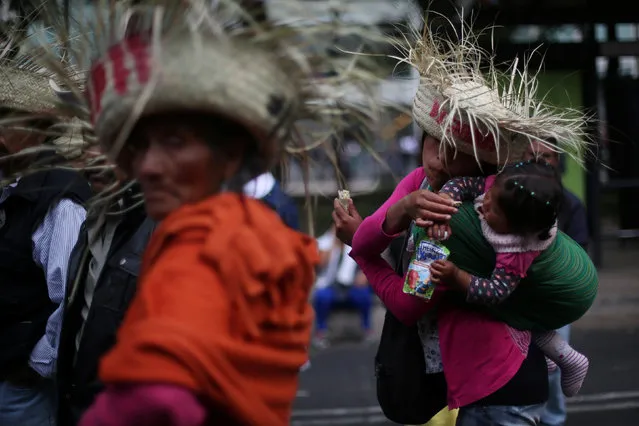Indigenous people march as a mother gives food to her daughter during a protest against a fuel price hike in Mexico City, Mexico, January 31, 2017. (Photo by Edgard Garrido/Reuters)