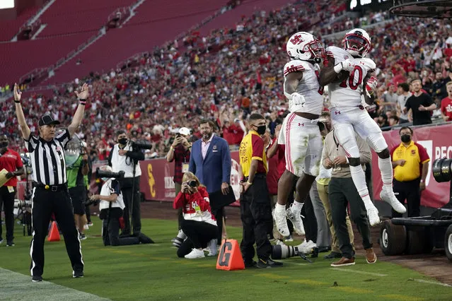 Utah wide receiver Money Parks (10) celebrates his touchdown reception with running back TJ Pledger during the first half of the team's NCAA college football game against Southern California on Saturday, October 9, 2021, in Los Angeles. (Photo by Marcio Jose Sanchez/AP Photo)