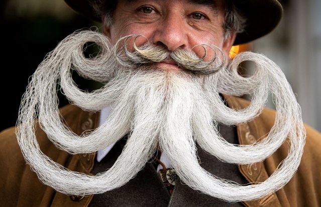 Participant Norbert Dopf from Austria arrives for the German Moustache and Beard Championships 2021 at Pullman City Western Theme Park in Eging am See, Germany, October 23, 2021. (Photo by Lukas Barth/Reuters)