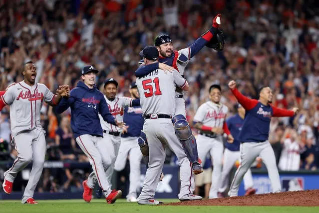 Will Smith #51 and Travis d'Arnaud #16 of the Atlanta Braves celebrate the team's 7-0 victory against the Houston Astros in Game Six to win the 2021 World Series at Minute Maid Park on November 02, 2021 in Houston, Texas. (Photo by Elsa/Getty Images)