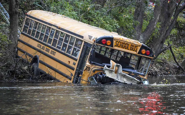 An eastern Pennsylvania school bus is shown after crashing into the Bushkill Creek in Easton, Pa., Monday, November 8, 2021. The school bus went off the road and ended up with its nose in a creek, sending the driver and eight students to hospitals, but no serious injuries were reported, authorities said. (Photo by Tim Wynkoop/The Express-Times via AP Photo)