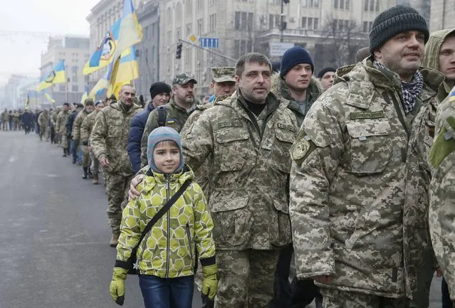 Veterans and their relatives attend a ceremony to commemorate Ukrainian servicemen, who were killed during a military conflict near the town of Debaltseve in the east of the country in 2015, in Kiev, Ukraine, February 18, 2017. (Photo by Valentyn Ogirenko/Reuters)