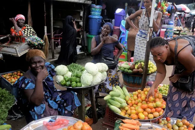 Women sells vegetables at Kaporo market in Conakry, Guinea Monday, September 13, 2021. (Photo by Sunday Alamba/AP Photo)