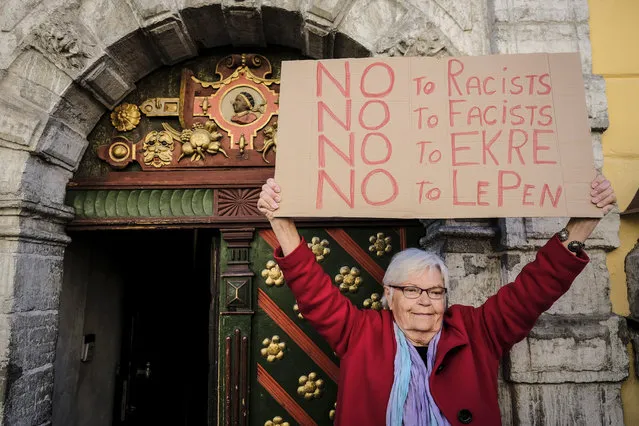 An activist protests against a meeting of Leader of the French National Front Marine Le Pen with Jaak Madison, member of Conservative People's Party of Estonia, Finns Party representative Olli Kotro, Danish People's Party representative Anders Vistisen, and Manuel Vescovi of Italy's Lega Nord at the House of the Blackheads in Tallinn, Estonia on Tuesday, May 14, 2019. (Photo by Hendrik Osula/AP Photo)