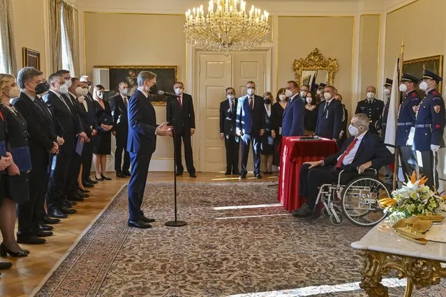 Czech President Milos Zeman (in a wheelchair) appoints the ministers of the new Czech five-party cabinet led by Petr Fiala (Civic Democrats), comprising also the Mayors and Independents, Christian Democrats, TOP 09 and the Pirates, at the presidential manor in Lany, Czech Republic, Friday, December 17, 2021. (Photo by Vit Simanek/CTK via AP Photo/Pool)