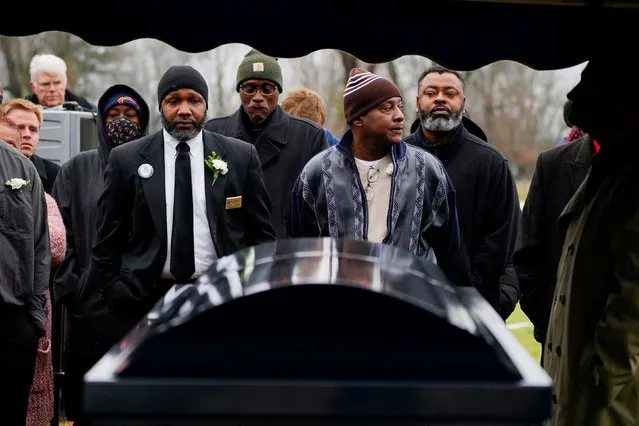 Community members look on as the casket of corrections officer Robert Daniel is lowered into his grave at the Maplewood Cemetery in Mayfield, Kentucky, U.S., December 18, 2021. Officer Daniel was killed on December 10 while directing workers and inmates, under his care, to safety following a devastating outbreak of tornadoes that ripped through several U.S. states. (Photo by Cheney Orr/Reuters)