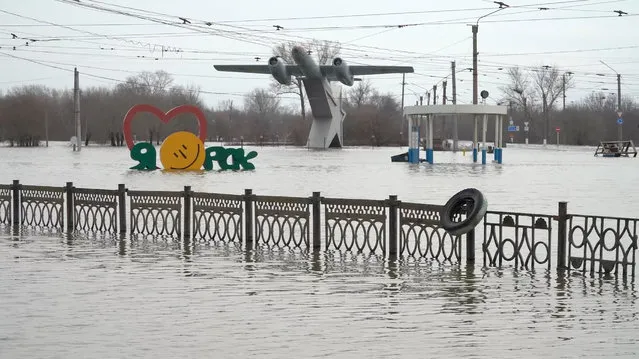 A view shows a sign reading “I love Orsk” near a monument to aviators in a flooded street of Orsk, Russia on April 9, 2024, in this still image taken from video. (Photo by Reuters TV)
