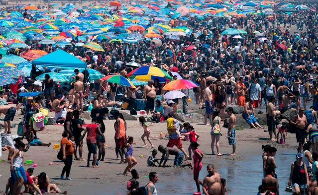 Beachgoers spend their day in the hot weather at the Coney Island Beach on July 4, 2019 in New York. (Photo by Don Emmert/AFP Photo)