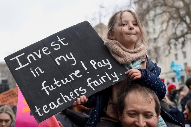 A child holds a placard as striking workers attend a march, in London, Britain on February 1, 2023. (Photo by Toby Melville/Reuters)