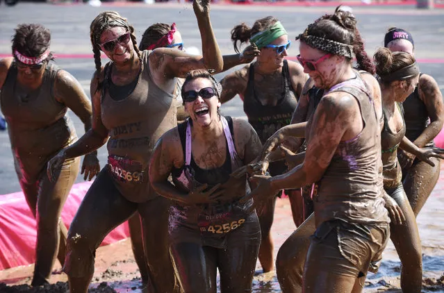 Participants have fun with the final obstacle during the Dirty Girl Mud Run at the Sears Centre in Hoffman Estates, Ill., on Saturday, June 27, 2015. (Photo by Joe Lewnard/Daily Herald via AP Photo)
