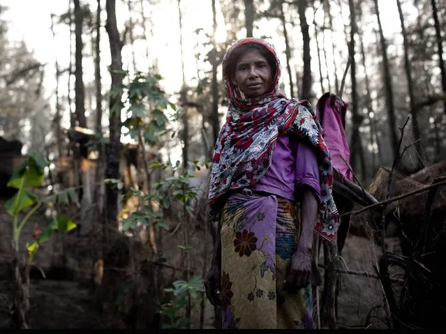 45 year old Dilbhar looks towards the camera as she stands in the Shamalapur Rohingya refugee settlement in Chittagong district. She escaped to Bangladesh from the Bodchara village in the Mondu district of Myanmar. (Photo by Getty Images/Stringer)