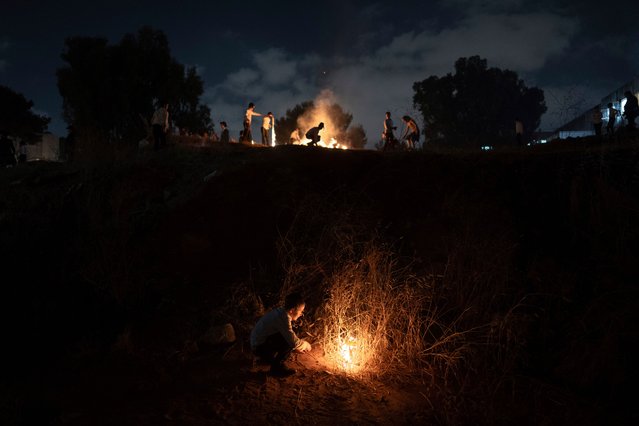 Ultra-Orthodox Jews light a bonfire during celebrations for the Jewish holiday of Lag BaOmer in Bnei Brak, Israel, Saturday, May 25, 2024. The holiday marks the end of a plague said to have decimated Jews during the Roman times. (Photo by Oded Balilty/AP Photo)
