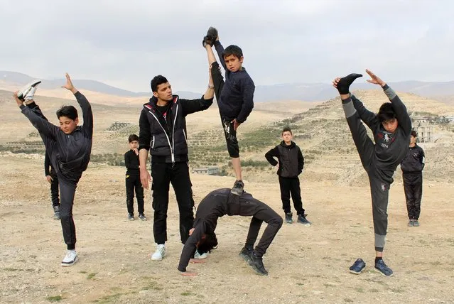 Boys take part in an open-air training session with Syrian martial arts Coach Hassan Mansour in Barada Valley, in Damascus suburb, Syria on February 27, 2022. (Photo by Firas Makdesi/Reuters)