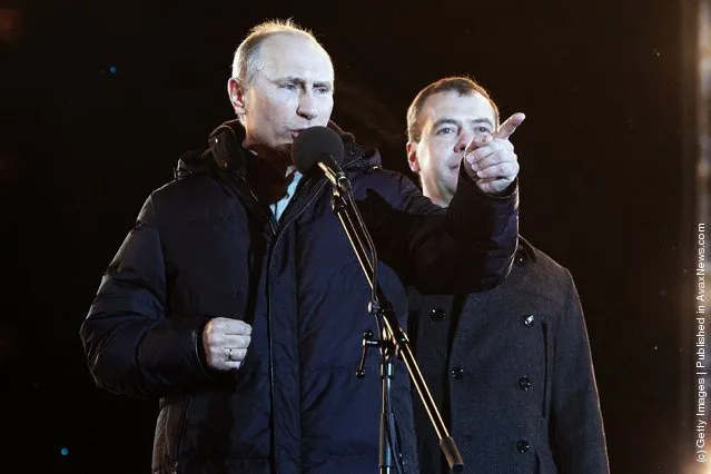 Russian Prime Minister and presidential candidate Vladimir Putin speaks as current President Dmitry Medvedev (R) listens during a rally after Putin claimed victory in the presidential election at the Manezhnya Square March, 4, 2012 in Moscow, Russia