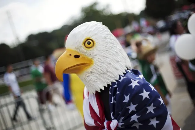 A fan wearing an eagle mask enters the CONCACAF Gold Cup semifinal playoff soccer games featuring Jamaica against the United States and Mexico against Panama Wednesday, July 22, 2015, in Atlanta. (Photo by David Goldman/AP Photo)