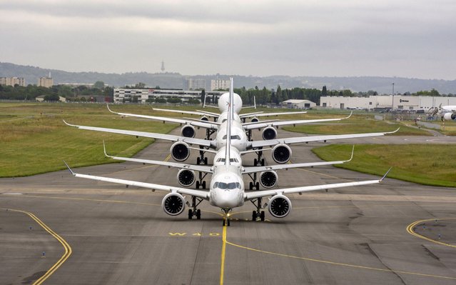 A handout picture released by Airbus on May 29, 2019 shows Airbus commercial aircrafts on the tarmac in Toulouse as the company is celebrating its 50th anniversary. Fifty years ago at the Paris air show, France's transport minister and Germany's economy minister signed an agreement that would change aviation history. The year was 1969 and Europe needed a smaller, lighter and more cost-effective passenger aircraft than American rivals. Five years later, the A300B2 was born, a short-to-medium range plane with two engines, despite safety concerns in an era when three engines was the standard minimum. (Photo by Jean-Vincent Reymondon/Airbus/AFP Photo)