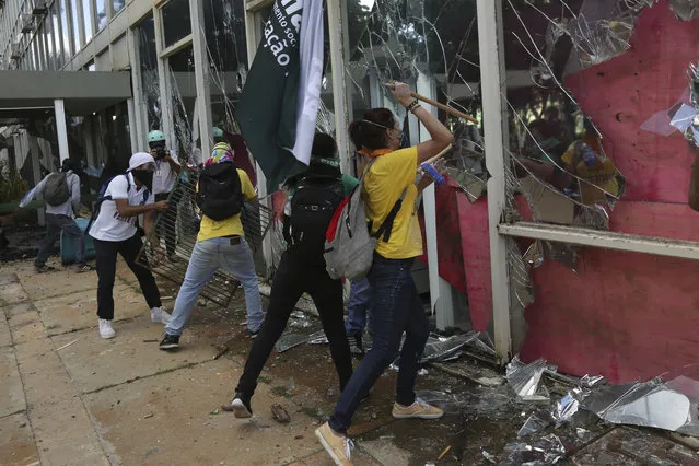 Demonstrators ransack the Ministry of Science and Technology during an anti-government protest in Brasilia, Brazil, Wednesday, May 24, 2017. Brazil’s president ordered federal troops to restore order in the country’s capital following the evacuation of some ministries during clashes between police and protesters who are seeking the leader’s ouster. (Photo by Eraldo Peres/AP Photo)