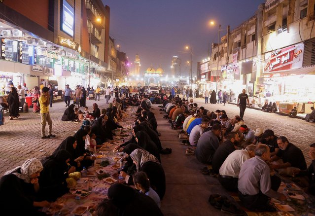 Iraqi Muslims eat Iftar, the meal to end their fast at sunset, during the holy fasting month of Ramadan, in Baghdad's Kadhimiya district, Iraq, April 9, 2022. (Photo by Ahmed Saad/Reuters)
