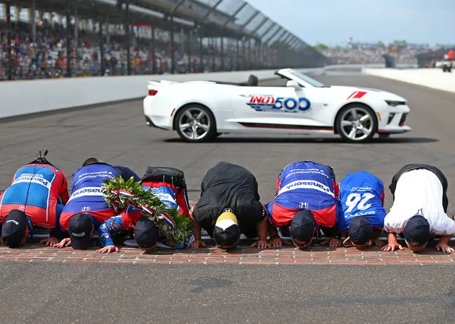 May 28, 2017; Indianapolis, IN, USA; IndyCar Series driver Takuma Sato and crew kiss the bricks as he celebrates after winning the 101st Running of the Indianapolis 500 at Indianapolis Motor Speedway. (Photo by Mark J. Rebilas/USA TODAY Sports)