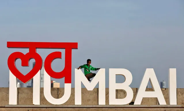 A boy plays on an installation at a wall along the sea front promenade in Mumbai, India June 2, 2016.  The installation reads “Love Mumbai”. (Photo by Shailesh Andrade/Reuters)
