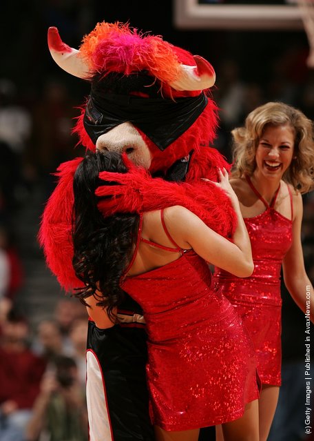 Benny the Bull, mascot for the Chicago Bulls, kisses a Luvabulls dancer while they perform against the Memphis Grizzlies