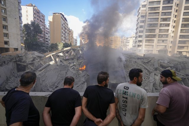 People check the site of an Israeli airstrike in Dahiyeh, Beirut, Lebanon, Wednesday, October 2, 2024. (Photo by Hassan Ammar/AP Photo)