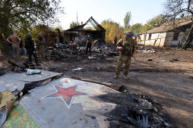 Ukrainian soldiers inspect the crash site of a downed Russian warplane in Kostyantynivka, Donetsk region, Ukraine in early October 2024. (Photo by Serhiy Nuzhnenko/Radio Free Europe/Radio Liberty)