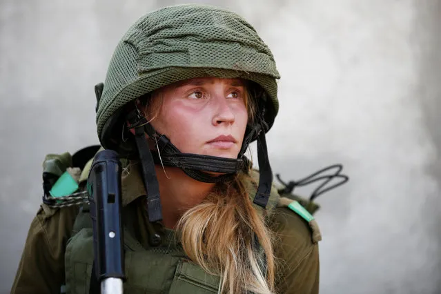 An Israeli soldier from the Home Front Command Unit takes part in an urban warfare drill inside a mock village at Tze'elim army base in Israel's Negev Desert June 11, 2017. (Photo by Amir Cohen/Reuters)