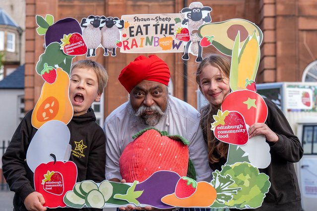 Pupils Antonio Marin-Kalisz, 10 (left) and Zofia Krolikwska, 11 (right) from St Mary's Primary School in Leith, UK with local celebrity chef Tony Singh at the unveiling of Edinburgh Community Food's new educational tuk-tuk on Wednesday, October 2, 2024. The tuk-tuk will serve as a mobile educational initiative to teach communities about nutrition by making healthy cooking fun and accessible, and taking it into the heart of the community. (Photo by Jane Barlow/PA Images via Getty Images)