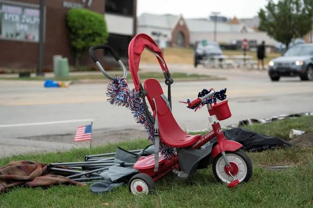 A tricycle is seen near the scene of a mass shooting at a Fourth of July parade route in the wealthy Chicago suburb of Highland Park, Illinois, U.S. July 4, 2022. (Photo by Max Herman/Reuters)