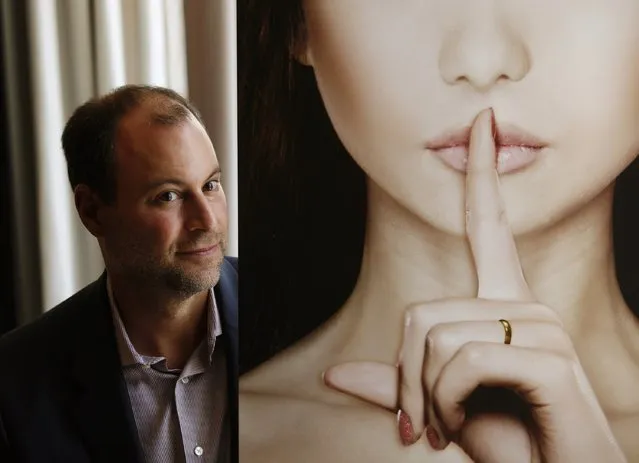 Ashley Madison founder Noel Biderman poses with a poster during an interview at a hotel in Hong Kong in this August 28, 2013 file photo. Emails sent by the founder of infidelity website AshleyMadison.com  appear to have been exposed in a second, larger release of data stolen from its parent company, Vice Media's online technology site Motherboard reported August 20, 2015. (Photo by Bobby Yip/Reuters)