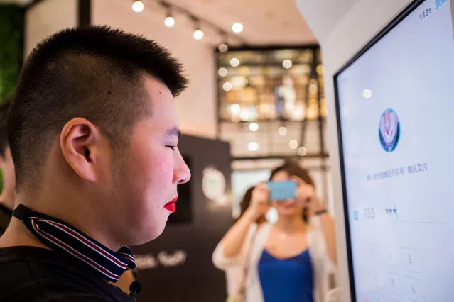 A customer tries Alipay's facial recognition payment solution “Smile to Pay” at KFC's new KPRO restaurant in Hangzhou, Zhejiang province, China September 1, 2017. (Photo by Reuters/China Stringer Network)