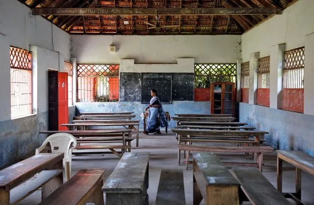 A staff member walks inside an empty classroom of a school after Kerala state government ordered the closure of schools across the state, amid coronavirus fears, in Kochi, India on March 12. 2020. (Photo by Sivaram V/Reuters)