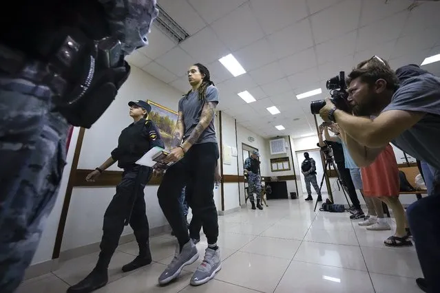 WNBA star and two-time Olympic gold medalist Brittney Griner is escorted from a court room ater a hearing, in Khimki just outside Moscow, Russia, Thursday, August 4, 2022. A judge in Russia has convicted American basketball star Brittney Griner of drug possession and smuggling and sentenced her to nine years in prison. (Photo by Alexander Zemlianichenko/AP Photo)
