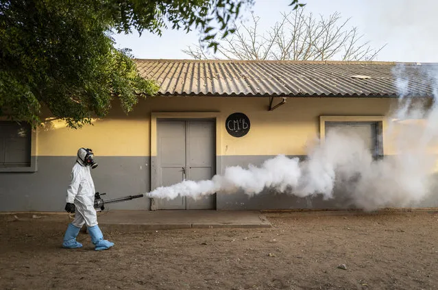 In this Wednesday, April 1, 2020, photo, a municipal worker sprays disinfectant at a school to help curb the spread of the new coronavirus in Dakar, Senegal. (Photo by Sylvain Cherkaoui/AP Photo)