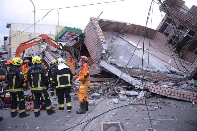 In this photo provided by Hualien City Government, firefighters are seen at a collapsed building during a rescue operation following an earthquake in Yuli township, Hualien County, eastern Taiwan, Sunday, September 18, 2022. A strong earthquake shook much of Taiwan on Sunday, toppling at least one building and trapping two people inside and knocking part of a passenger train off its tracks at a station. (Photo by Hualien City Government via AP Photo)