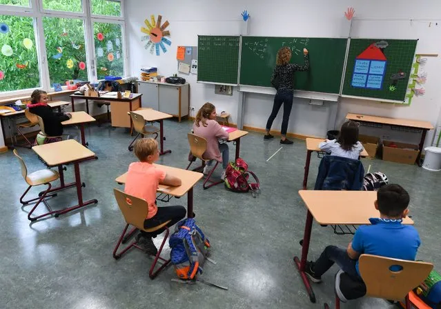 Students of class 4C of the Robert Schumann Primary School sit at a distance from each other in the classroom with their teacher Sylke Wassmann, on June 10, 2020 in Wiesbaden, Hessen, Germany. (Photo by Arne Dedert/picture alliance via Getty Images)