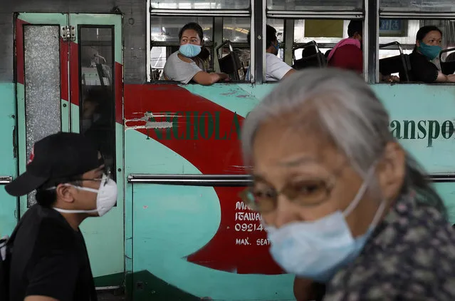 People ride a bus during the first day of a more relaxed lockdown that was placed to prevent the spread of the new coronavirus in Manila, Philippines on Monday, June 1, 2020. Traffic jams and crowds of commuters are back in the Philippine capital, which shifted to a more relaxed quarantine with limited public transport in a high-stakes gamble to slowly reopen the economy while fighting the coronavirus outbreak. (Photo by Aaron Favila/AP Photo)