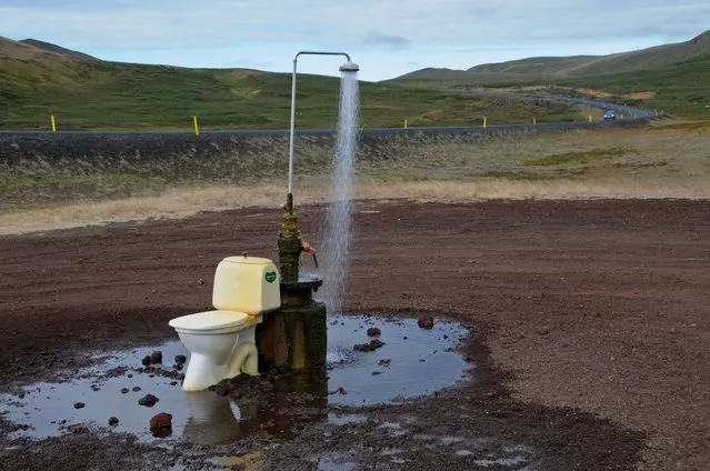 An open-air toilet and a hot spring shower are seen in the middle of nowhere on the road to the Krafla geothermal power station and lava fields, near Reykjahlid and Lake Myvatn in northeastern Iceland, on August 19, 2012. (Photo by Mariana Suarez/AFP Photo)