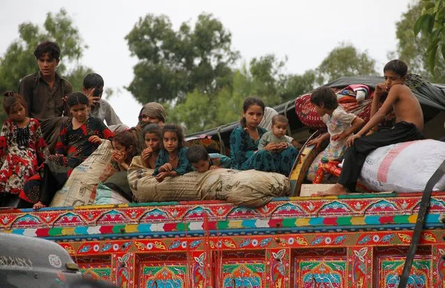 Children sit in the back of a truck as they prepare to return to Afghanistan, at a U.N. refugee repatriation center in Peshawar, Pakistan August 2, 2016. (Photo by Fayaz Aziz/Reuters)