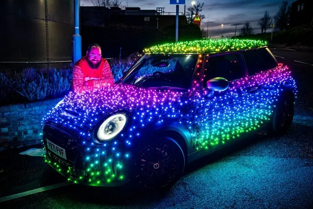 Nico Martin with his illuminated, charity fundraising “Festive Mini” car, at the Mini Plant in Oxford on November 17, 2022. The driver of a Mini decorated in 3,000 twinkling lights hopes to “bring little moments of joy to people's lives” this Christmas and raise over £10,000 for charity.  (Photo by Ben Birchall/PA Images via Getty Images)