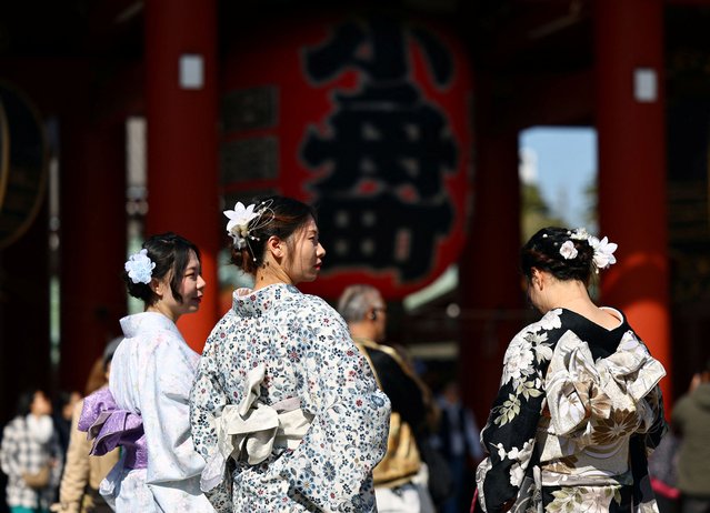 Tourists wearing Japanese traditional kimono clothes stroll near Sensoji temple at Asakusa district, a popular sightseeing spot in Tokyo, Japan on March 10, 2025. (Photo by Issei Kato/Reuters)