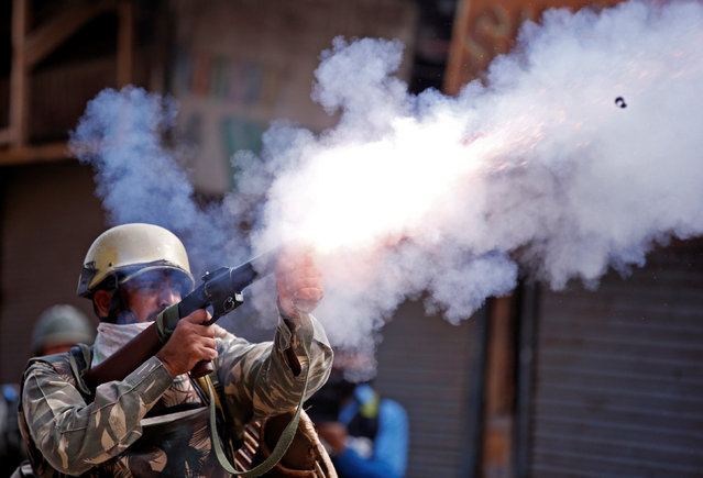 An Indian policeman fires a teargas shell towards demonstrators during a protest against the recent killings in Kashmir, in Srinagar September 13, 2016. (Photo by Danish Ismail/Reuters)
