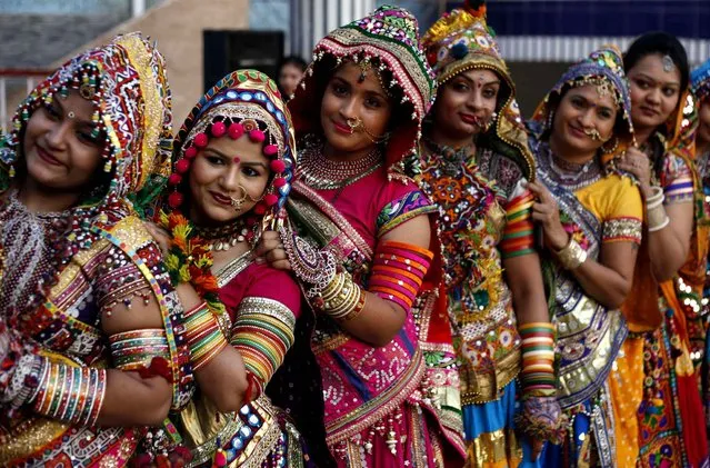 Indian girls in traditional attire pose for photographs as they practice the Garba, the traditional dance of Gujarat state, ahead of Navratri festival in Ahmadabad, India, Saturday, October 3, 2015. Navratri or nine night festival will begin on Oct. 13. (Photo by Ajit Solanki/AP Photo)