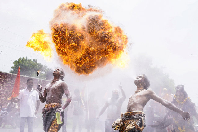 Revellers perform a fire-breathing stunt as they take part in a religious procession during the “Kanwar Yatra” pilgrimage in the sacred month of Shravan, in Ajmer, India on July 29, 2025. (Photo by Himanshu Sharma/AFP Photo)