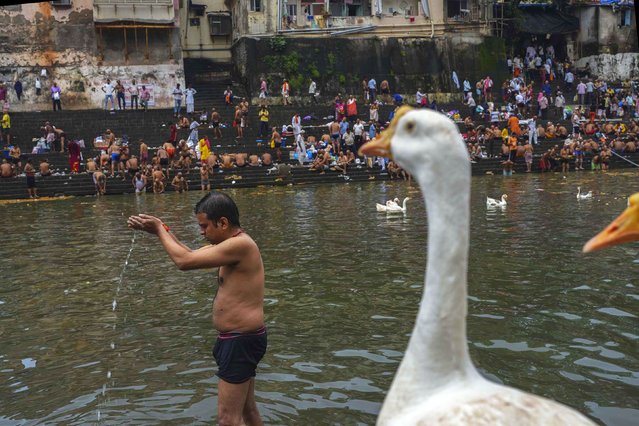 A Hindu devotee performs rituals during the Mahalaya festival in Mumbai, India, on Sunday, September 21, 2025. (Photo by Rafiq Maqbool/AP Photo)