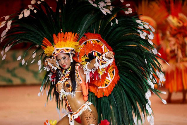 A member of the Boi Bumba Garantido association performs during the Boi Bumba folklore festival at the Bumbodromo in Parintins, Amazonas State, Brazil, on June 28, 2024. Parintins is well-known internationally for its Boi Bumba folklore festival, which lasts for three days in late June and whose themes, costumes, and songs are based on indigenous cultures of the Amazon rainforest. (Photo by Michael Dantas/AFP Photo)